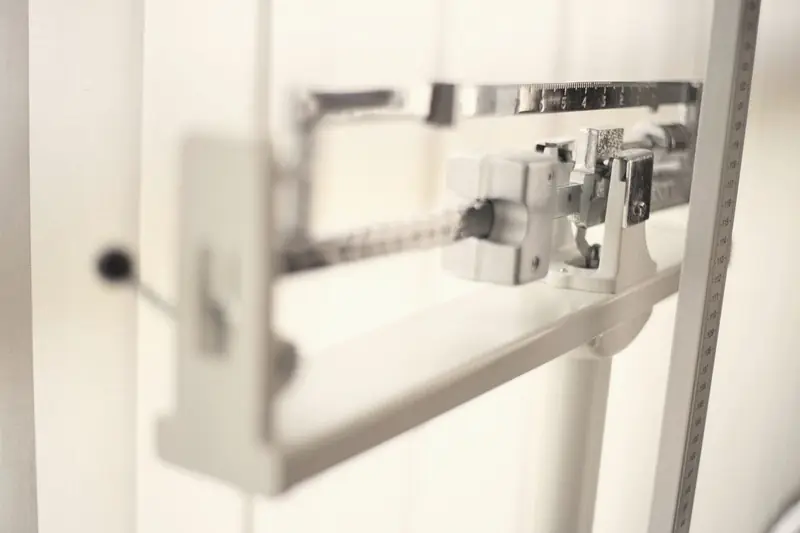 The beam and weights of a mechanical balance scale