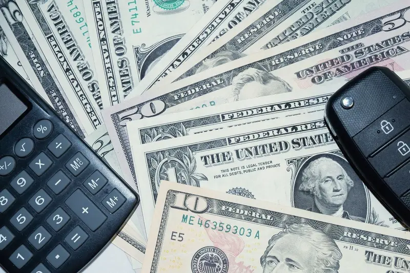 Car key and calculator on US dollar notes