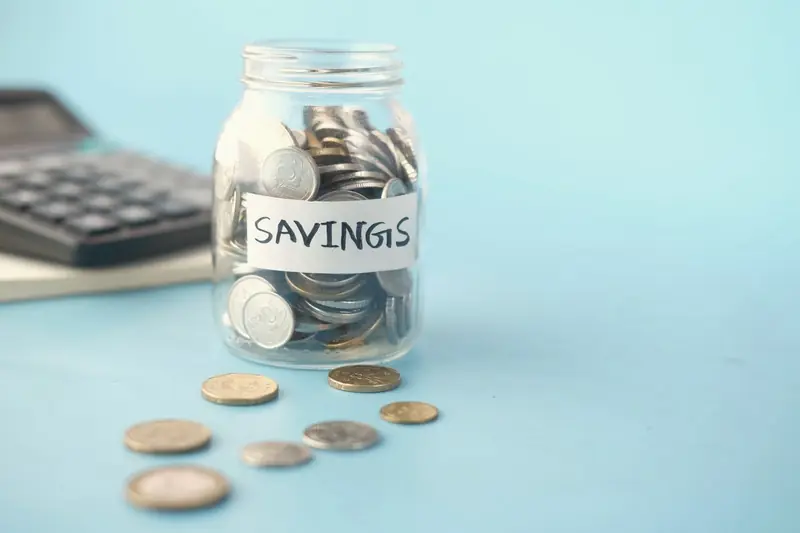 Glass savings jar filled with coins